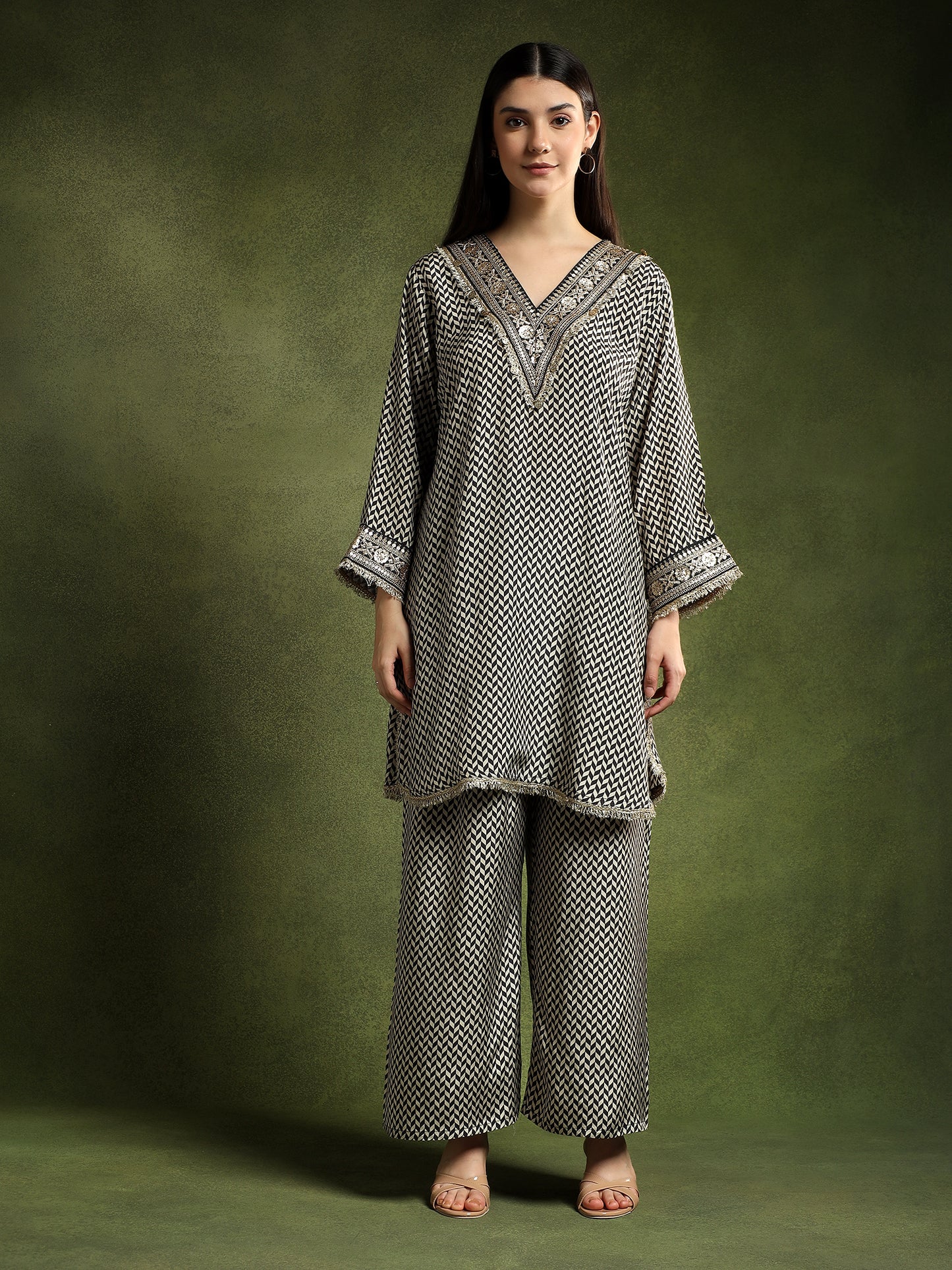 Woman wearing a patterned outfit against a green background