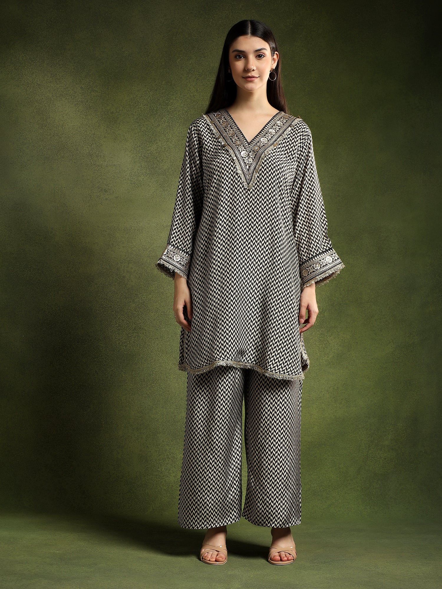 Woman wearing a patterned outfit against a green background