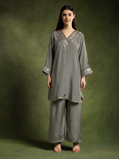 Woman wearing a patterned outfit against a green background