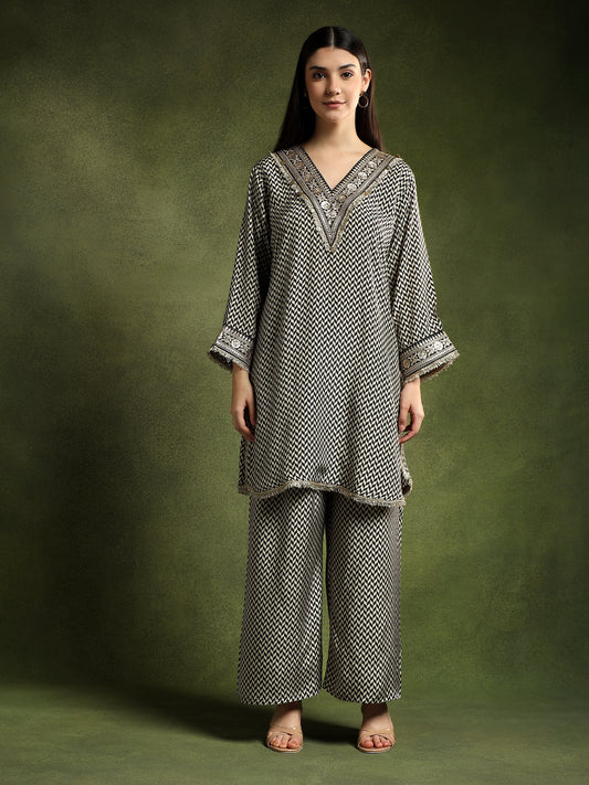 Woman wearing a patterned outfit against a green background